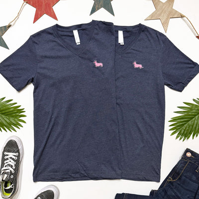 Navy blue t-shirt with pink dog icons on a white background with decorative elements.
